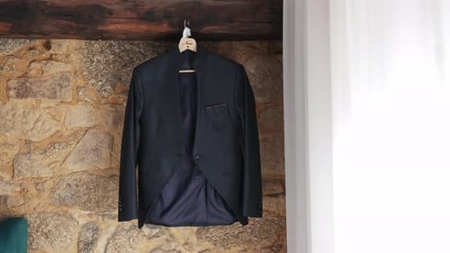 Elegant Groom's Suit Hanging Before a Wedding Ceremony