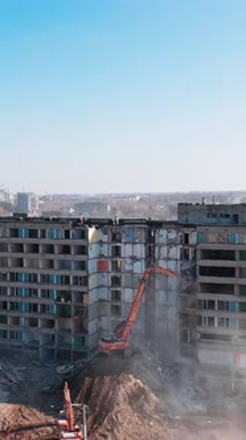 Excavator destroying building. Bulldozer constructive demolition.