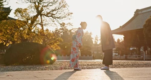 Japanese people at temple, bow and traditional clothes with hello, nature and sunshine with respect