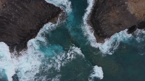 Waves Crashing Against Rocky Shoreline From Above