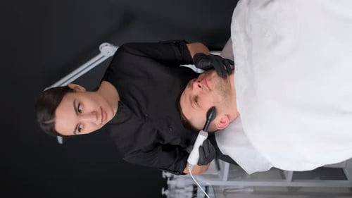 Young Man Receives Facial Treatment in Salon