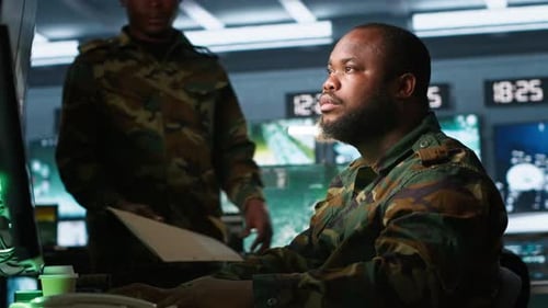Men Working at Computers in Futuristic Control Room