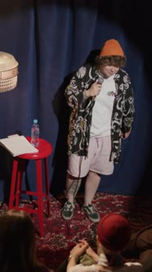 Gen Z Comic Performing Stand Up Monologue on Small Stage of Comedy Club