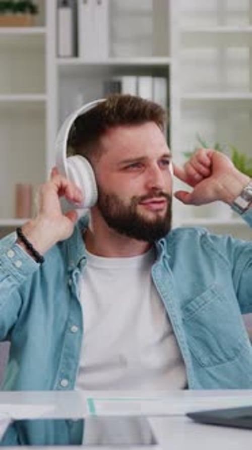 Man Listening Music with Headphones Dancing at Desk