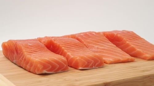Fresh Salmon Fillets on Wooden Cutting Board