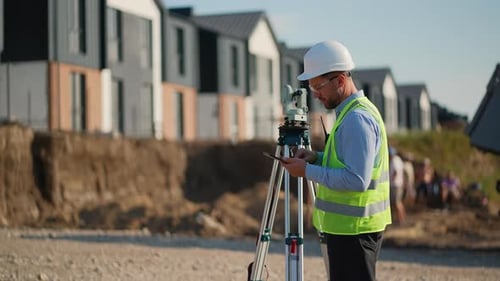 Surveyor Using a Theodolite for Measuring Land at a Construction Site