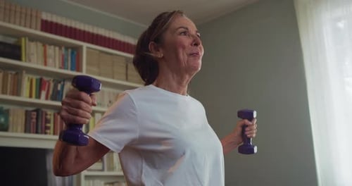 Active Senior Woman Exercising with Weights at Home