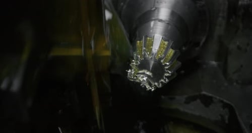 Slow motion macro of specialist is working on production of different gearing details in a worksho