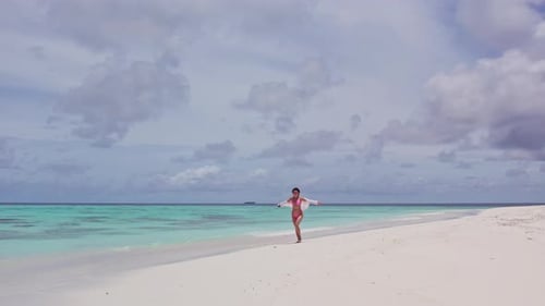 Girl Walking on a White Sand Beach in the Maldives