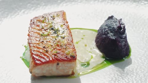 Grilled Salmon Steak with Sesame Seeds and Garnish in Modern Expensive Restaurant Close Up Shot of