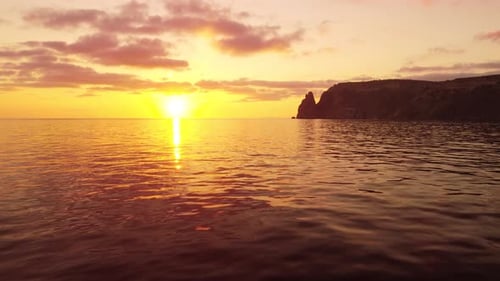 Aerial View on Sunset Over Calm Sea and Volcanic Rocky Shores
