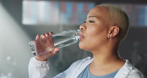 Drinking water, exercise and woman in gym, wellness and hydration with break, fitness and fatigue
