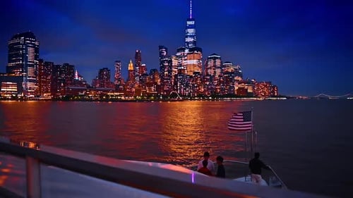Approaching the stunning luminous skyline of New York, USA at dusk time.