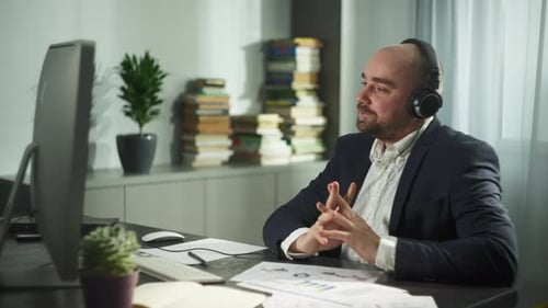 Businessman Has a Video Call on the Computer in the Home Office