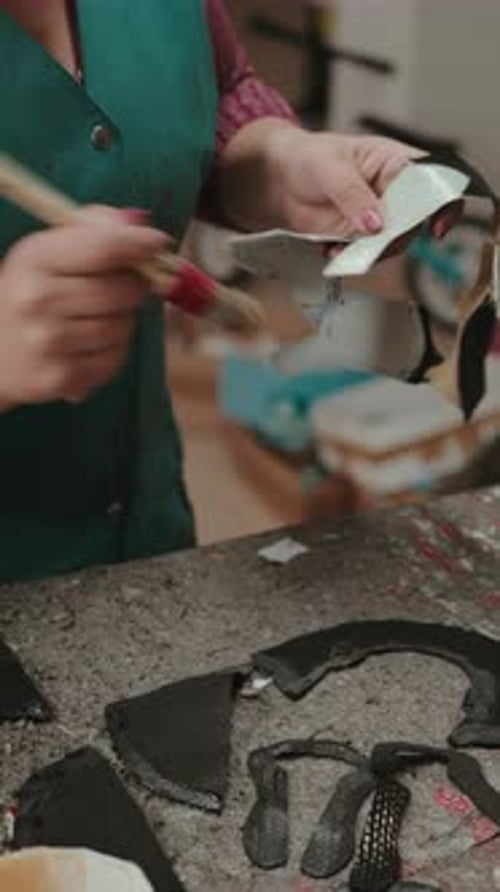 Woman Painting Craft Pieces in Workshop