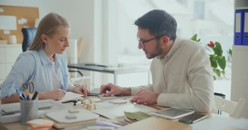 Interior Designers Working At Desk In Office Planning Interior Design