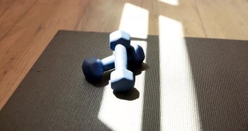 Yoga, equipment and weights with mat in studio for fitness, workout and morning routine