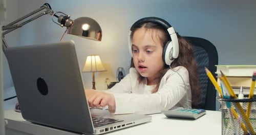 Girl Learning Online with Laptop and Headphones