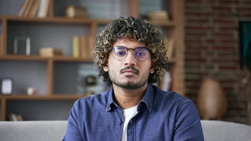 Young Adult Man Sits on Couch