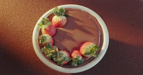 Pudding, chocolate and fruit on dessert in bakery with strawberries for decoration
