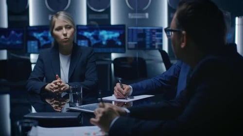 Business Meeting Around a Table in Dark Room