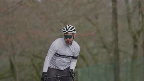 Cyclist riding road bike outdoors in slow motion