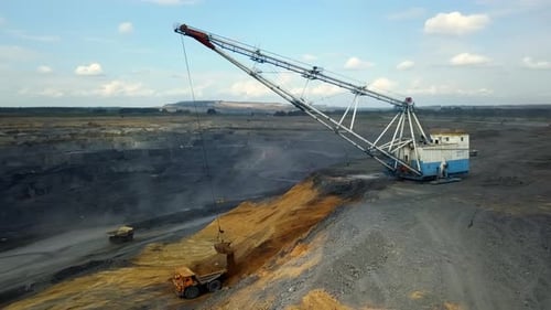 Heavy Machinery Is Actively Operating in An Open Pit Mining Site for Material Extraction Stock Clip