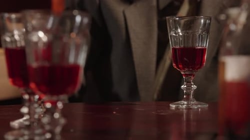 A Man in Desperation Slams His Fist on a Table on Which There are Glasses of Wine