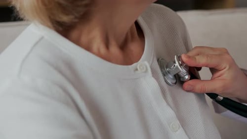 Doctor Examines Patient with Stethoscope in Office