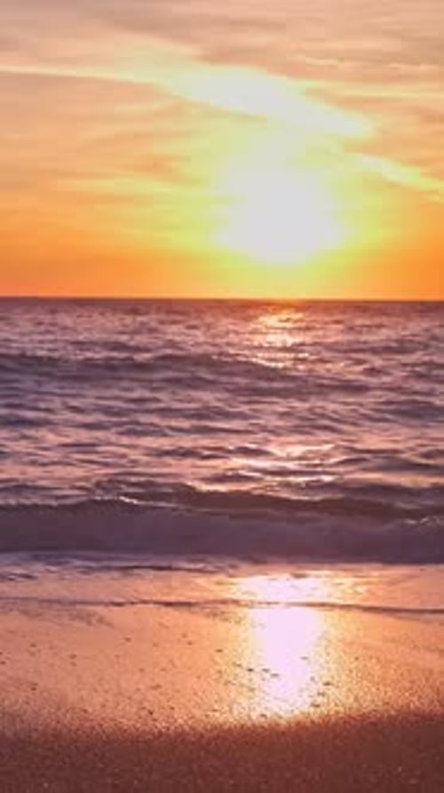 Colorful sunset over sea horizon, summer, low sun, tidal waves in close-up
