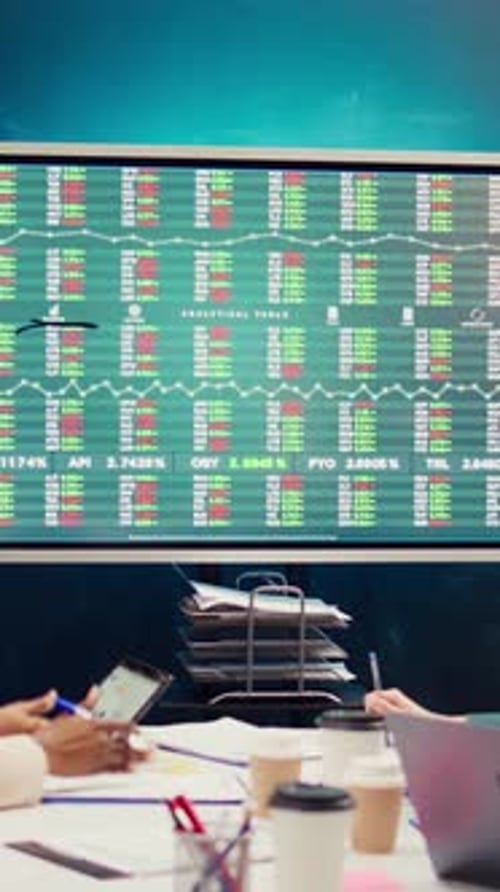 Team of Business Analysts Following Stock Trade Trends on Interactive Board