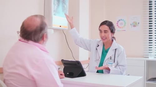 Female doctors explain to patient about X-ray film examination.