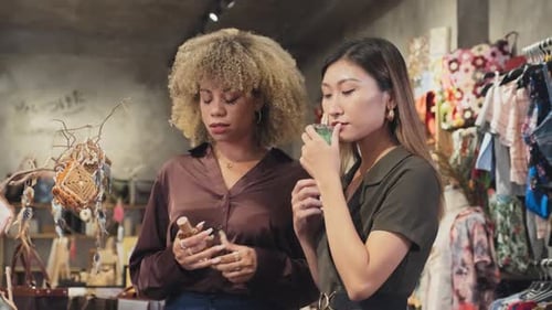 Girls Choosing Perfume in Boutique Shop