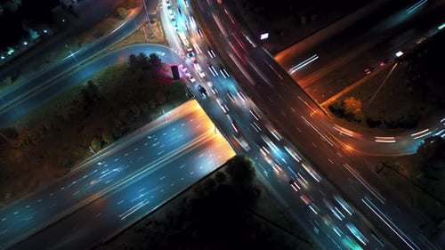 Fly Above Night Car Traffic in City Road at Top View Time Lapse