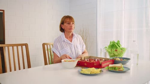 Woman Sitting at Table with Food