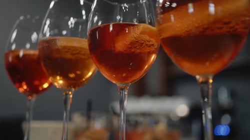 Close Up of Amber Cocktails in Wine Glasses