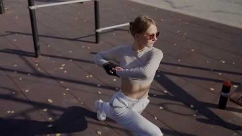 Athletic Woman Stretches in Urban Training Area