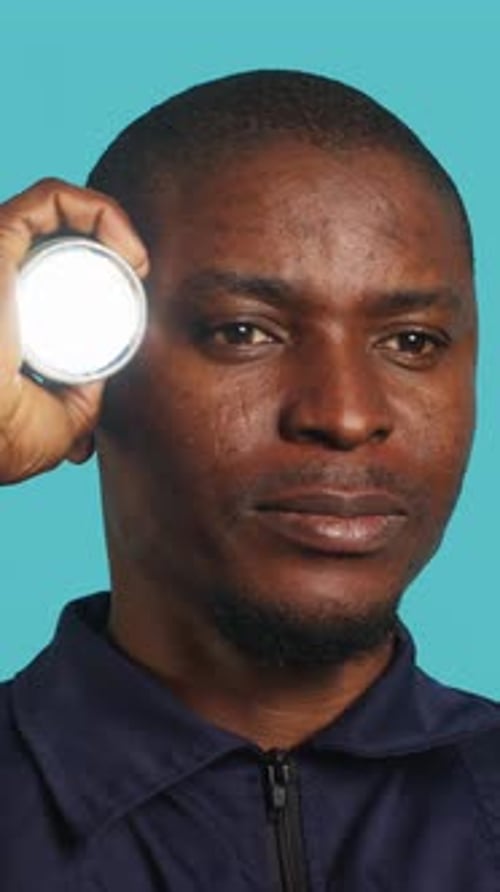 Vertical Video Headshot Portrait of Security Guardian Catching Intruders with Flashlight Close Up