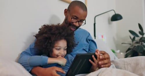 Father, child and relax with tablet on bed at house for reading online ebook