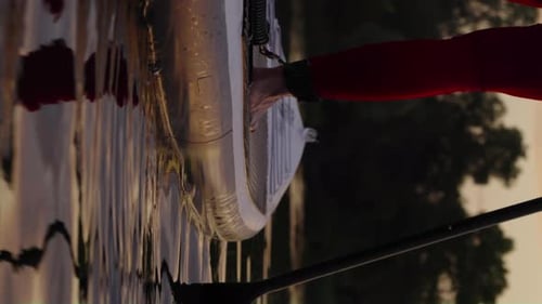 Person Paddleboarding at Sunset on the River