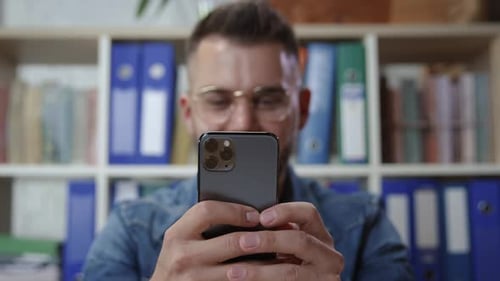 Happy Hipster Employee Using Smartphone Enjoying Work Break at Office Closeup Man Holding Modern