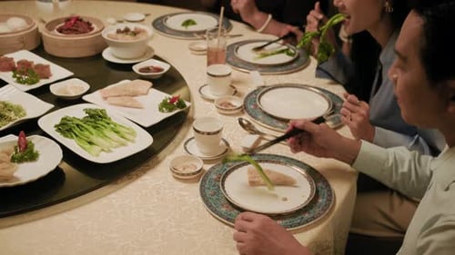 Members of Family Eating Various Dishes in Asian Restaurant