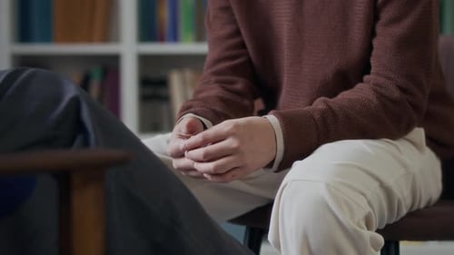 Young Man Feeling Anxious in front of Psychologist