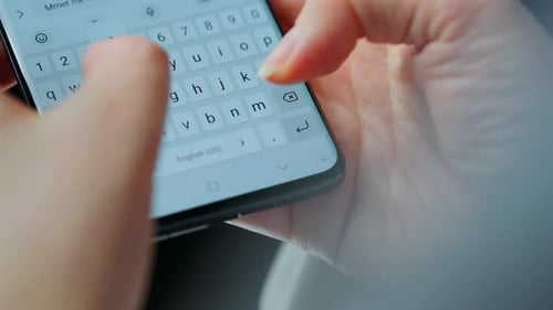 Female Hands Typing Text on Smartphone Closeup