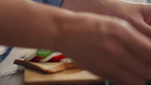 Preparing Caprese Sandwich with Fresh Ingredients on Toast