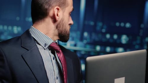 Male Professional Server IT Engineer Using Laptop in Data Center