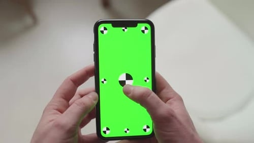 touch gestures using fingers on smartphone with green screen display with tracking markers, portrait