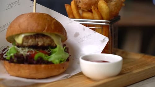 Close Up of Burger and Fries on a Board