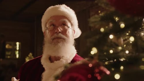 Santa Claus Preparing for Festive Season by Decorating Christmas Tree