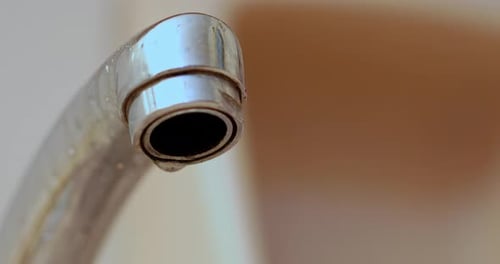 water drop from water tap, close up shot
